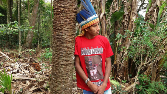 MC Kunumi poses for a photo in the Krukutu indigenous community, in the city of Sao Paulo, in October 2017. The rapper is wearing a t-shirt stamped with a picture of his appearence in the opening ceremony of Brazil's World Cup in 2014 where he held up a red-and-black poster with the word "demarcation now."