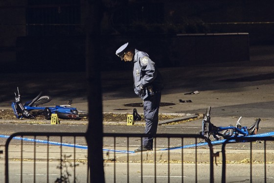 Image: A police officer stands guard on a bike path at the crime scene
