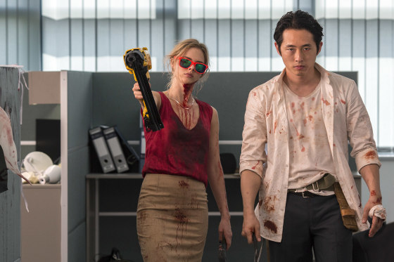 Samara Weaving as Melanie Cross and Steven Yeun as Derek Cho in the horror-action film "Mayhem," an RLJE Films release