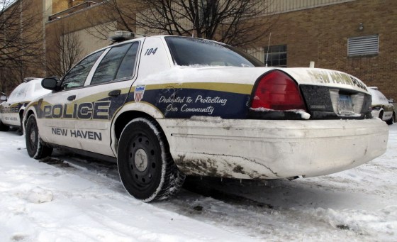 In this Tuesday, Feb. 9, 2016 photo, a police cruiser with a crack in the front sits parked behind the police department in New Haven, Conn.