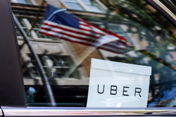 Image: An Uber sign is seen in a car in New York