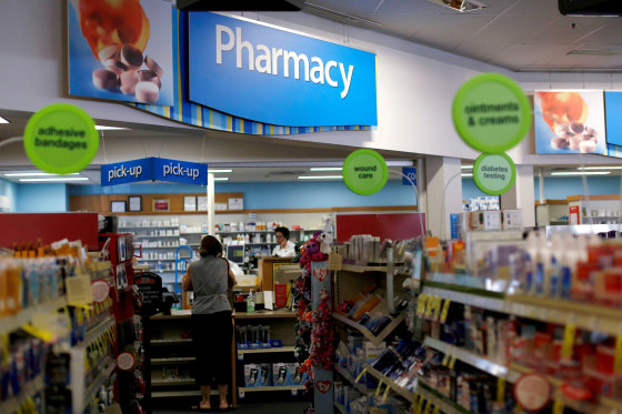 Image: A customer waits at the counter of a CVS Pharmacy store in Pasadena
