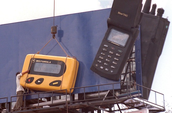 Image: A Worker Struggles to Install An Oversized Ad
