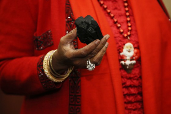 Image: Rep. Sheila Jackson Lee holds up a symbolic piece of coal