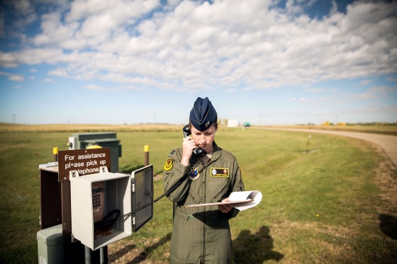 Image: Captain Amber Moore, 28, prepares to enter a capsule hidden 60 to 80 feet underground, where Air Force \"missileers\" like her control nuclear-capable intercontinental ballistic missiles, or ICBMS, in Minot, North Dakota.