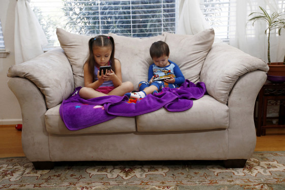 Image: Juliana Sanchez, 5, and her brother, Francisco Sanchez Jr., 2, watch children's programming on YouTube on their parent's cell phones at their home on March 9, 2015 in Mountain House, California.