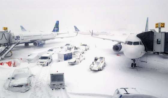 Image: Airplanes wait at the gates outside terminal five at John F. Kennedy International Airport