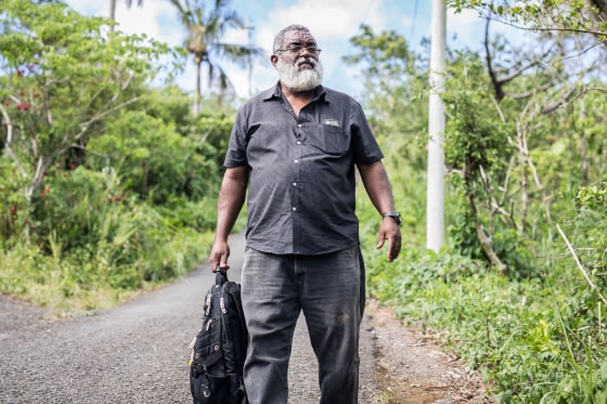 Dec. 9, 2017 - Frank Tolentino walks down a road in Adjuntas, Puerto Rico to deliver supplies to residents with no electricity or potable water.