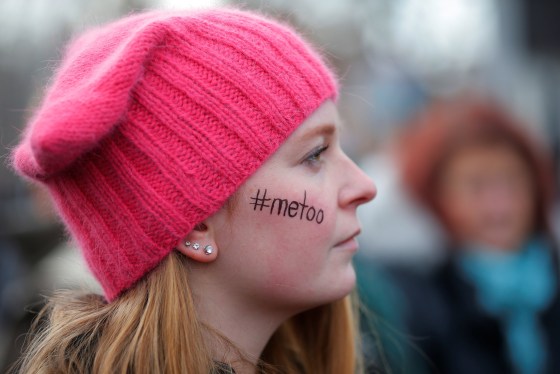 Image: Caitlyn MacGregor, with \"#metoo\" written on her face and wearing a pink \"pussyhat\", attends the second annual Women's March in Cambridge