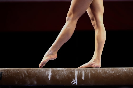 Image: Gymnast's feet on a balance beam