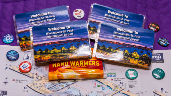 MSP airport is handing out SuperBowl buttons and free hand warmers for travelers.