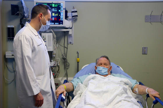 Image: Dr. Doug Olson asks patient William Ness, 70, how he is feeling after his wife drove him to the emergency room and he was diagnosed with flu at Northside Hospital Emergency Room in Cumming, Georgia, on Jan. 29, 2018.