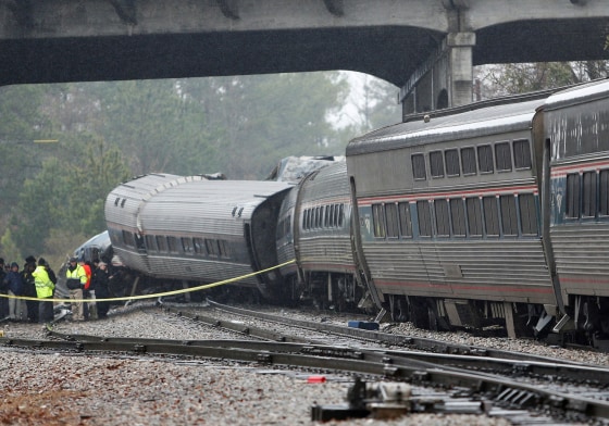 Image: Emergency responders view the damage at the scene after an Amtrak passenger train collided with a freight train and derailed in Cayce