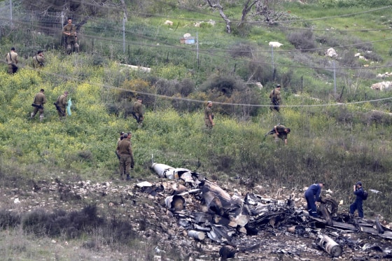 Image: Israeli soldiers inspect the remains of an Israeli F-16 fighter jet that was shot down after a hit by Syrian anti-aircraft system, near the northern Israeli Kibbutz (collective community) of Harduf, on Feb. 10, 2018.
