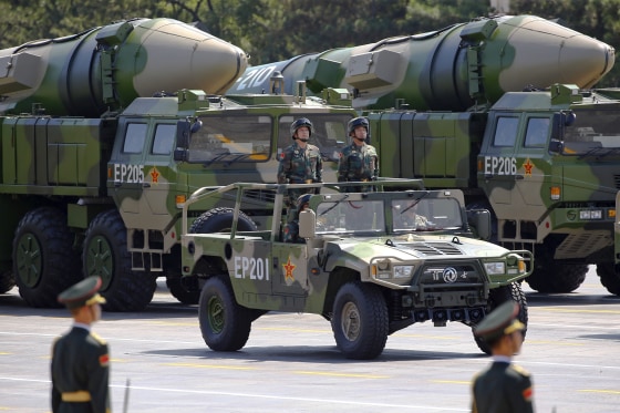 Military vehicles carrying DF-21D ballistic missiles roll through Tiananmen Square in 2015.