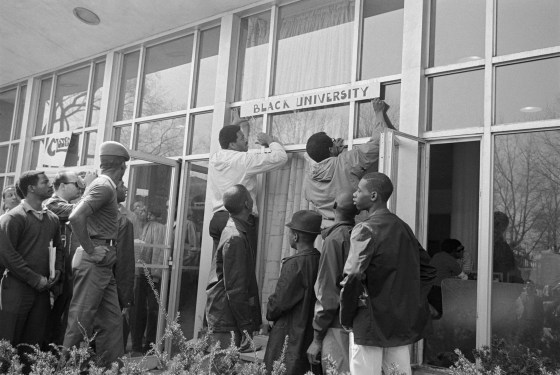 Image: Howard University students hang a sign in protest on the school's administration building
