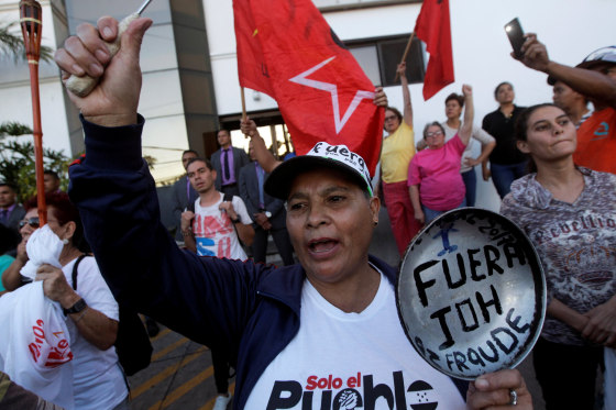 Image: Demonstrator holds a frying pan reading \"JOH out, Fraud\", referring to Honduran President Juan Orlando Hernandez, during a protest against Hernandez in Tegucigalpa