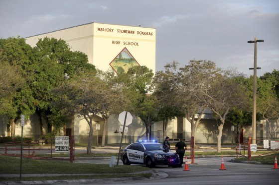 Image: Police watch the entrance of a parking lot at Marjory Stoneman Douglas High School on Feb. 23, 2018 in Parkland, Florida. Teachers and administrators returned for the first time since the Valentine's Day shooting that killed several people.