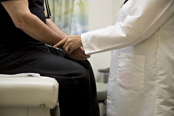 Image: A doctor examines a patient