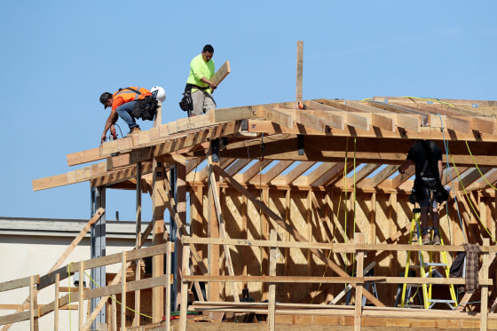 Image: Construction workers build a new home in Manhattan Beach