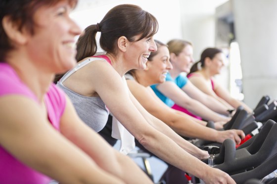 Image: Women riding exercise bikes