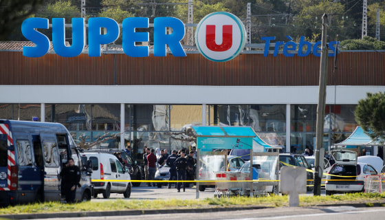 Image: A general view shows gendarmes and police officers at a supermarket after a hostage situation in Trebes