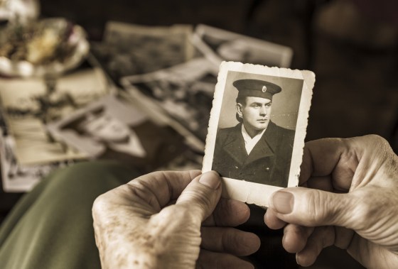 Senior woman holding dear photograph of her husband