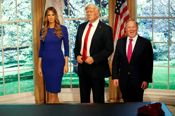 Image: Former White House Press Secretary Sean Spicer poses next to a newly unveiled wax figure of first lady Melania Trump standing next to a wax figure of her husband, U.S. President Donald Trump, at the Madame Tussauds in New York City