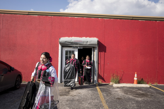 Image: Las Alte?as, an all-female mariachi group, leave their rehearsal space