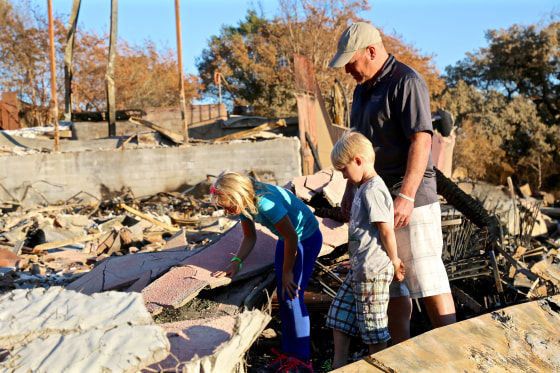 Image: Rene Byck brings son Brycen, age 6, and daughter Adianka, age 9, to the site where their family-owned Paradise Ridge Winery stood until it was reduced to rubble by the Tubbs Fire on Oct. 9, 2017.