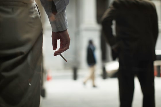 Image: Men smoke outside of a building in New York
