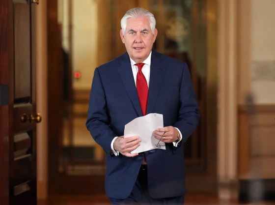 Image: Rex Tillerson walks to a podium before making a statement at the State Department