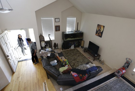 Image: Ina Rogers, left, leaves her home in Fairfield, California