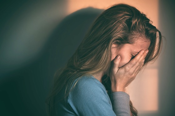 Image: Woman sitting alone and depressed