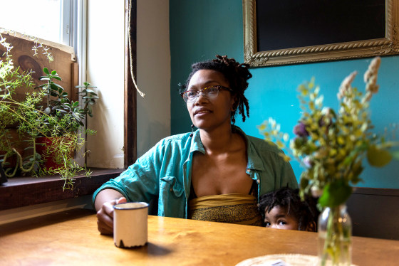 Image: Blew Kind, owner of Franny Lou's Porch, sits with her 3-year-old daughter, Rosetta
