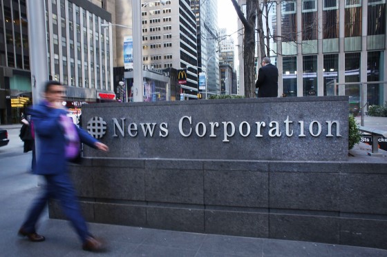 Image: A man walks by the News Corporation headquarters