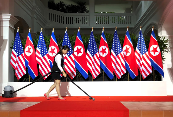 Image: Worker vacuums spot where U.S. President Trump and North Korea's leader Kim are expected to shake hands at start of their summit in Singapore
