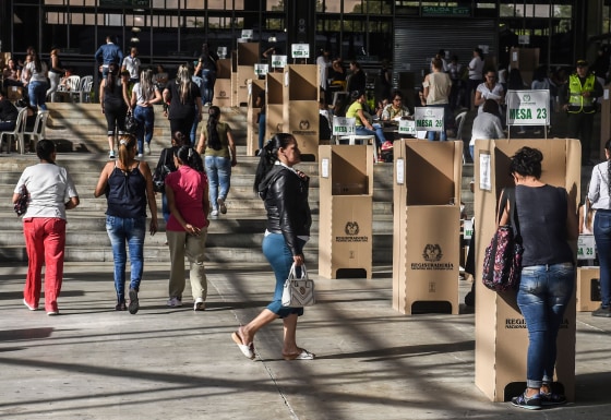 Image: People vote at a polling station during the presidential runoff election in Medellin