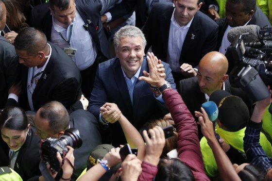 Image: Ivan Duque, candidate of the Democratic Center party, greets supporters after voting during the presidential runoff election in Bogota