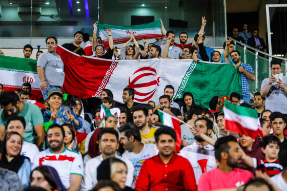 Image: People wave flags in Azadi stadium in Tehran