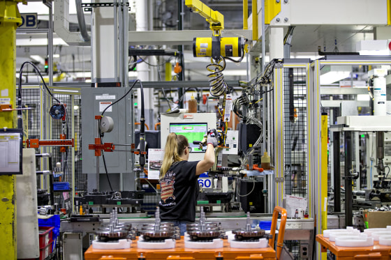 Image: An employee moves a flywheel assembly at the Harley-Davidson Inc. facility