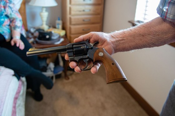Delmar Scroughams holds a gun from his collection on May 2, 2018.