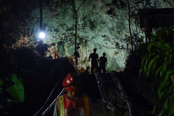 Image: Thai soldiers stand at the mouth of Tham Luang cave