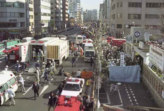 Image: The injured of the deadly gas attack are treated by rescue workers near Tsukiji subway station in Tokyo