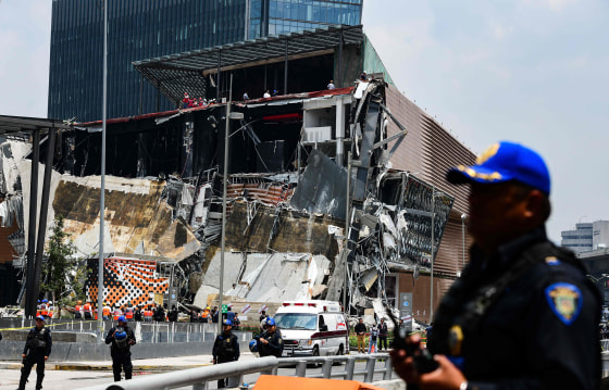 Image: Police officers secure the area after a a shopping mall partially collapsed in Mexico City