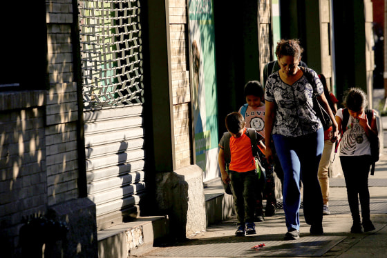 Image: Children are escorted to the Cayuga Center, which provides foster care and other services to immigrant children separated from their families, in New York