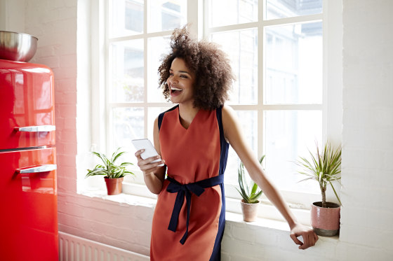Young woman laughing in a trendy apartment