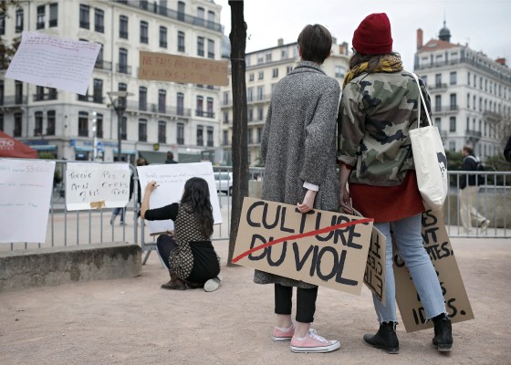 A woman holds a banner reading 'Rape culture' during a demonstration to support the wave of testimonies denouncing cases of sexual harassment, in Lyon, central France on Oct. 29, 2017.