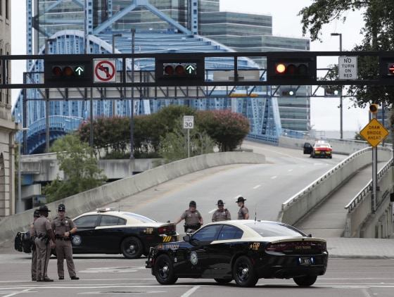 Image: Florida Highway patrolmen block the entrance to the Main Street Bridge near the scene of a mass shooting at Jacksonville Landing
