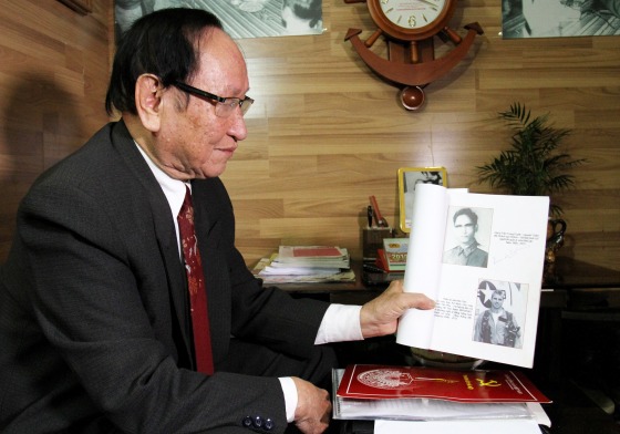 Tran Trong Duyet, the former director at the Hoa Lo prison in Hanoi, showing a photo at his home in Haiphong of US Senator John McCain